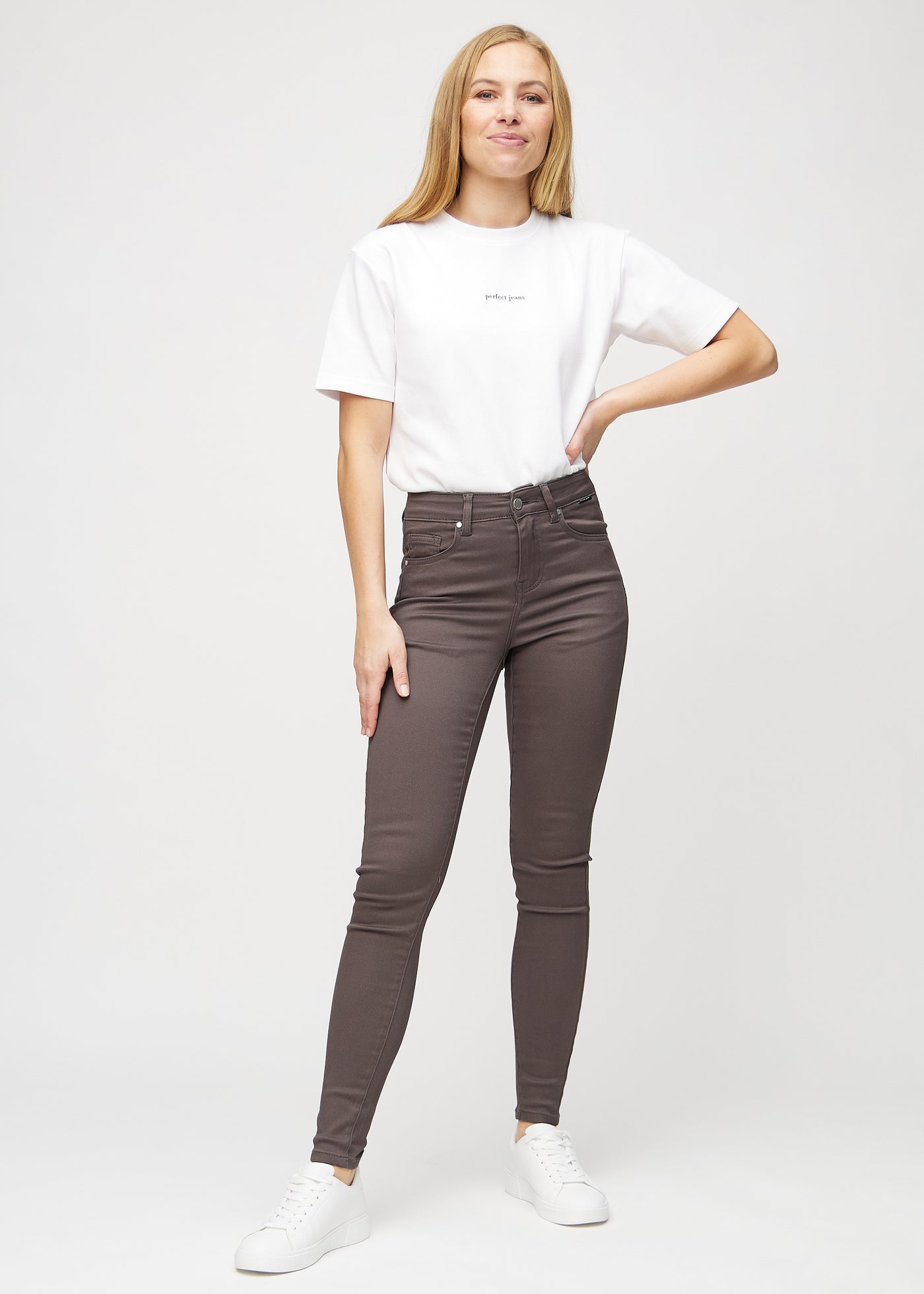 Fuldt billede af model i gråbrune skinny jeans.